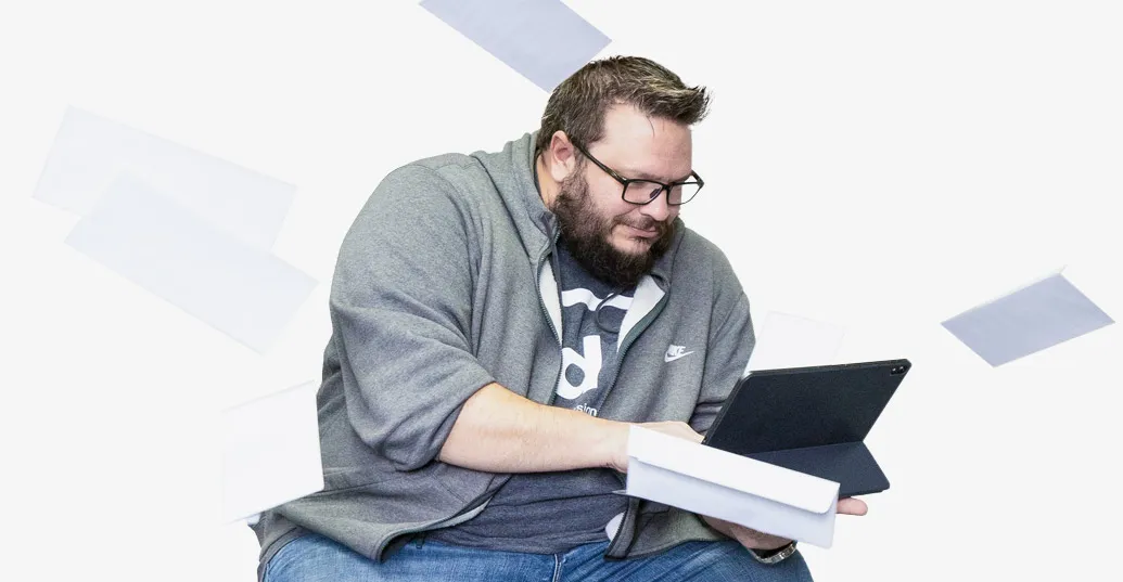 man typing on laptop with falling envelopes