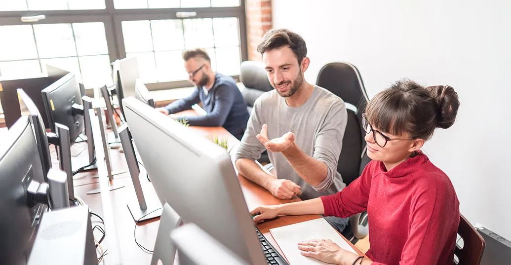 team at desk with computers